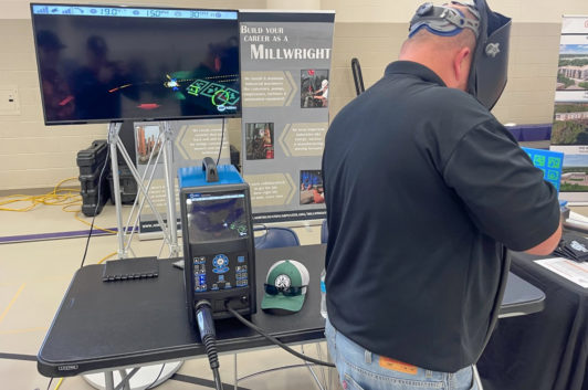 man demonstrating welding at career fair
